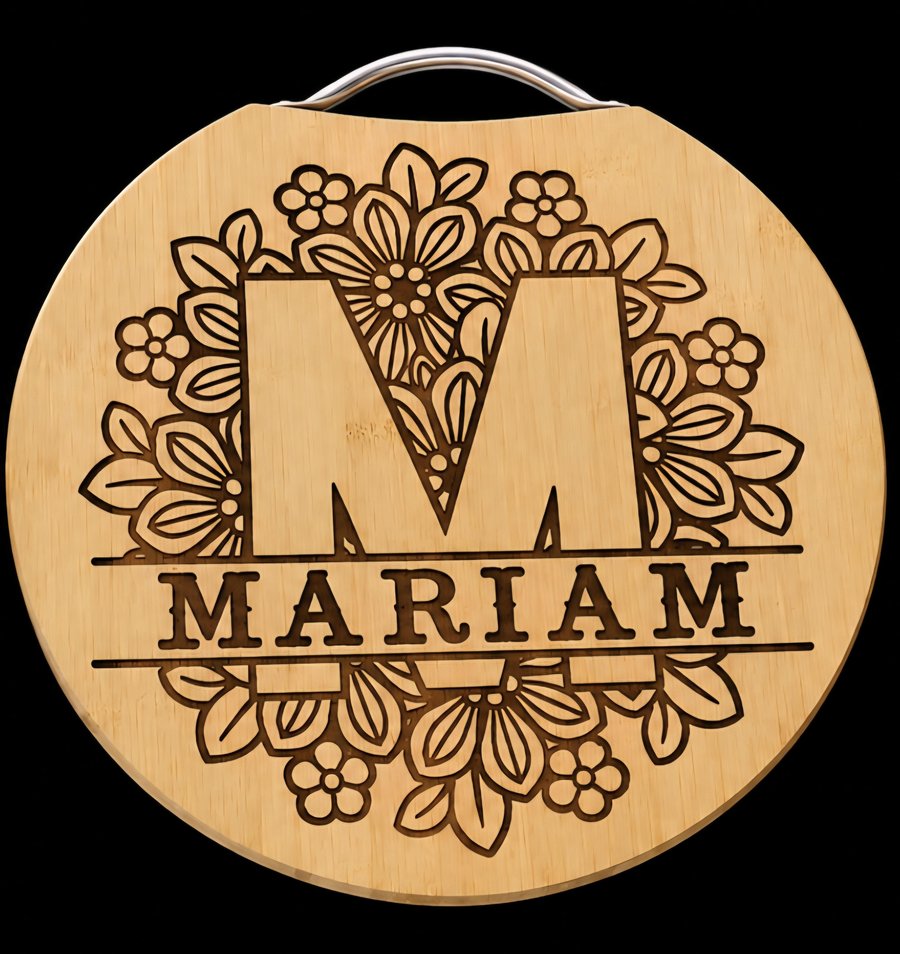 Round engraved wooden board with wire handle, floral monogram M and name Mariam