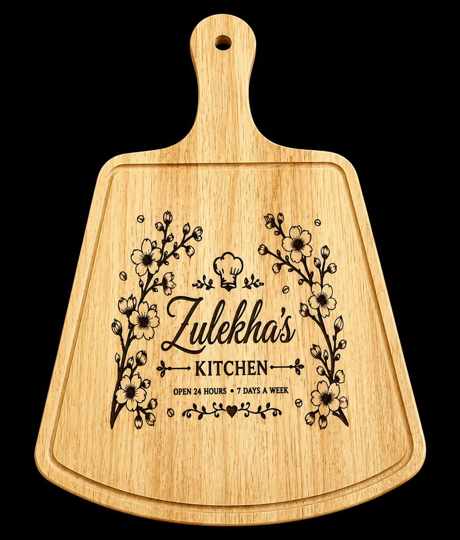 Engraved wooden paddle board with cherry blossom florals reading Zulekha's Kitchen